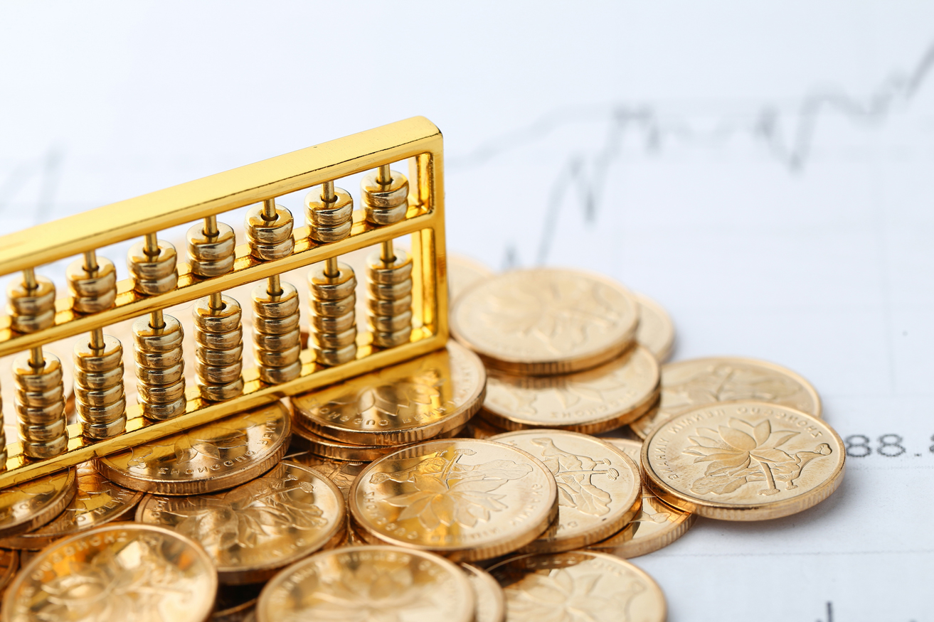 golden-abacus-with-chinese-rmb-gold-coins-as-background.jpg