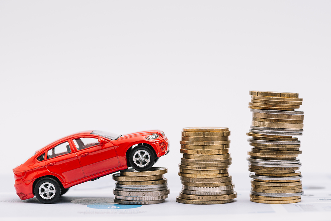 toy-car-going-up-increasing-stack-coins-against-white-background.jpg